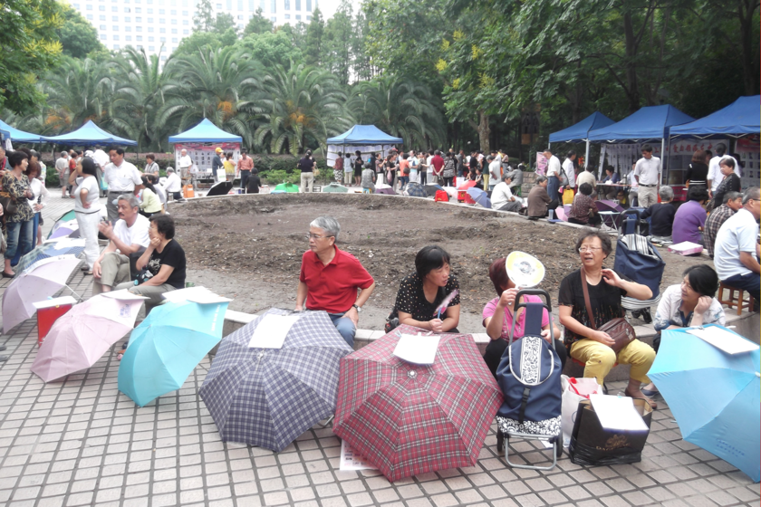 está en un parque lleno de padres con sombrillas
 – La nación